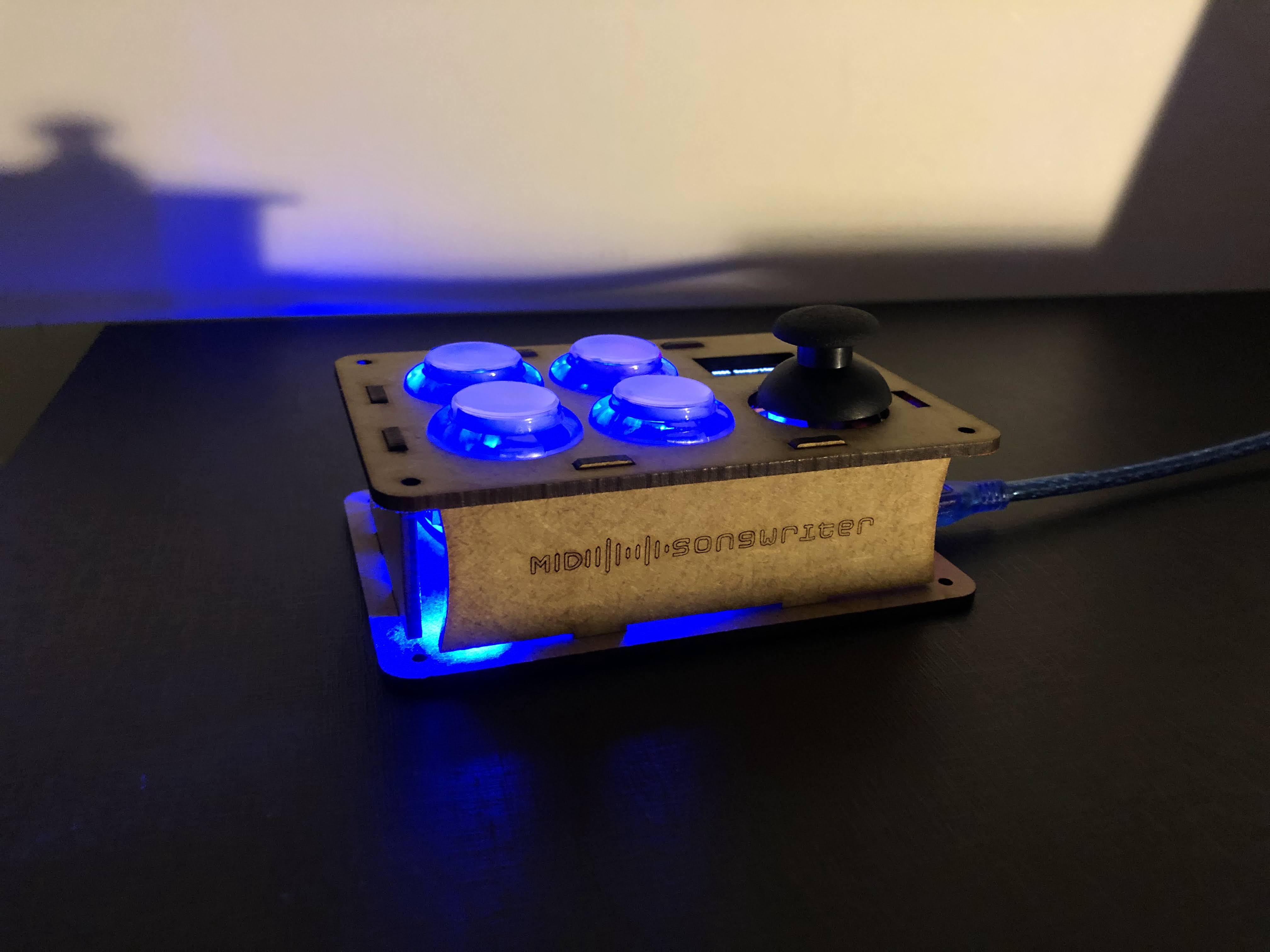 MIDI Songwriter assembled device glowing blue on a desk